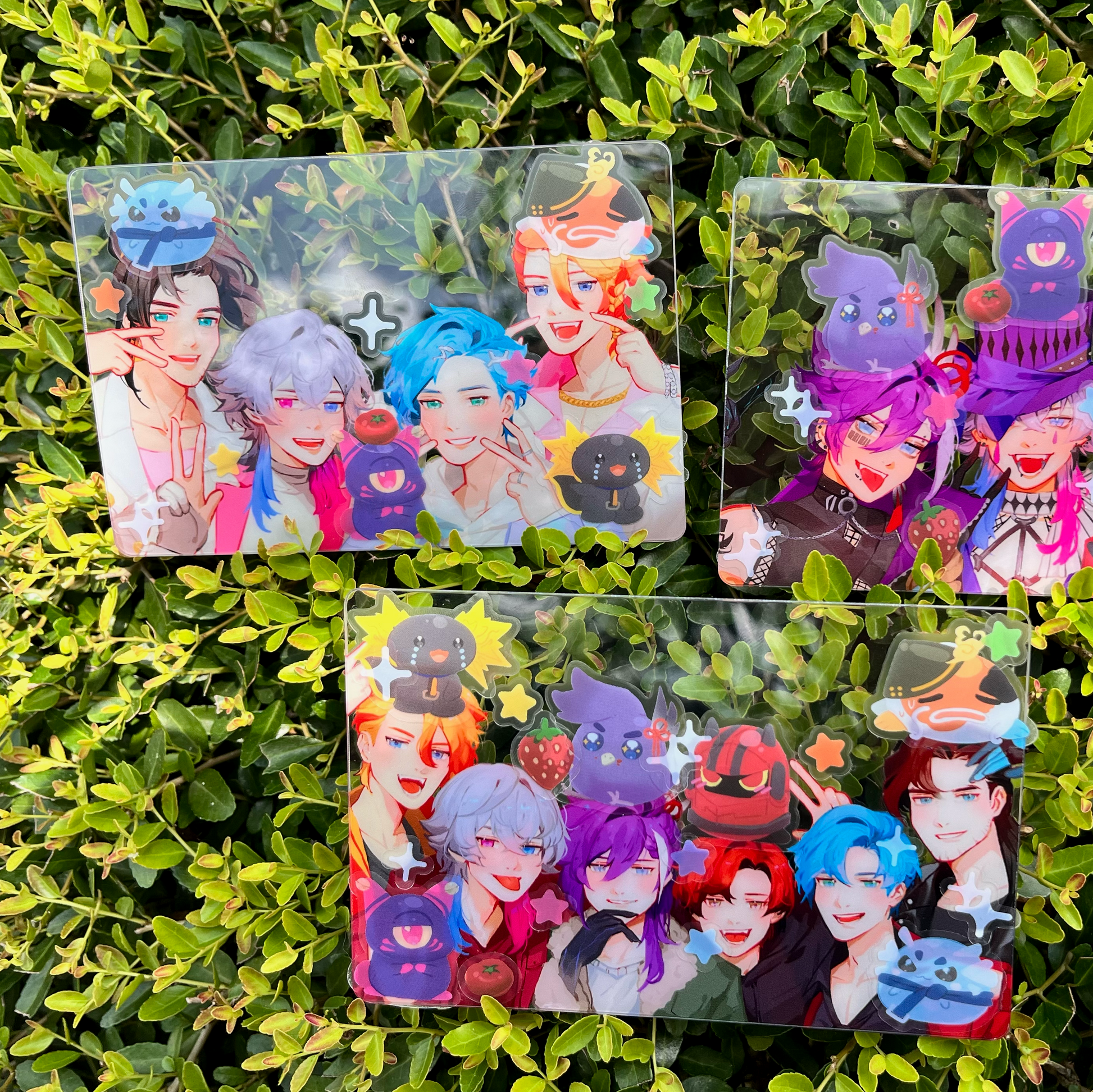 Four clear plastic packs with colorful character illustrations on a green leafy background